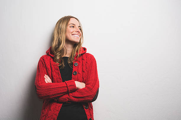 Young woman posing against the wall