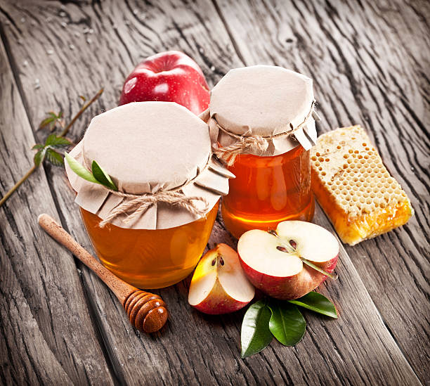 istock Glass cans full of honey, apples and combs. 531867237