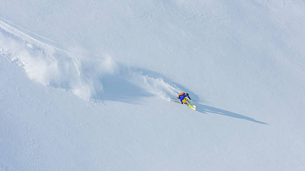 Male skier in snow Male skier enjoying skiing on snowy hills. backpack sprayer stock pictures, royalty-free photos & images