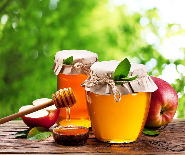 istock Glass cans full of honey and apples. 531868155