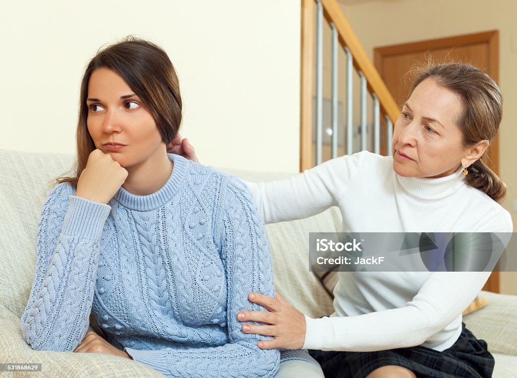 Mature woman tries asking apologies with teenage daughter Mature woman tries asking apologies with teenage daughter after conflict. Focus on girl 2015 Stock Photo