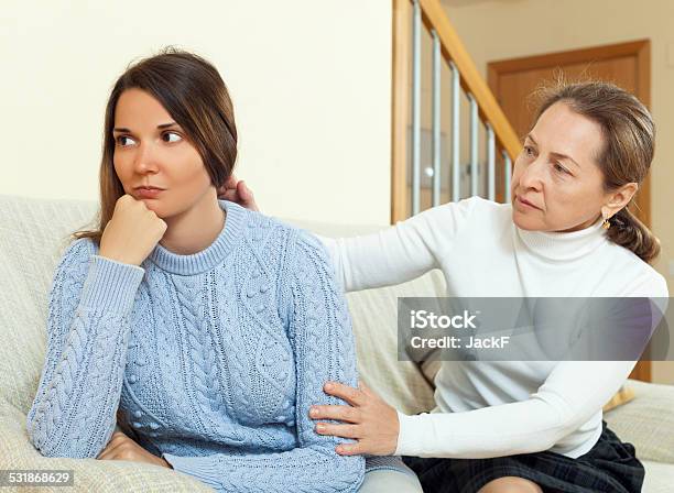 Mature Woman Tries Asking Apologies With Teenage Daughter Stock Photo - Download Image Now