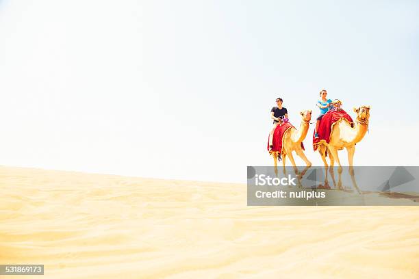 Tourists Riding Through The Desert Stock Photo - Download Image Now - 20-29 Years, 2015, Adult