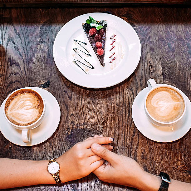 istock Close-up female and male hands holding on cafe table 531869942