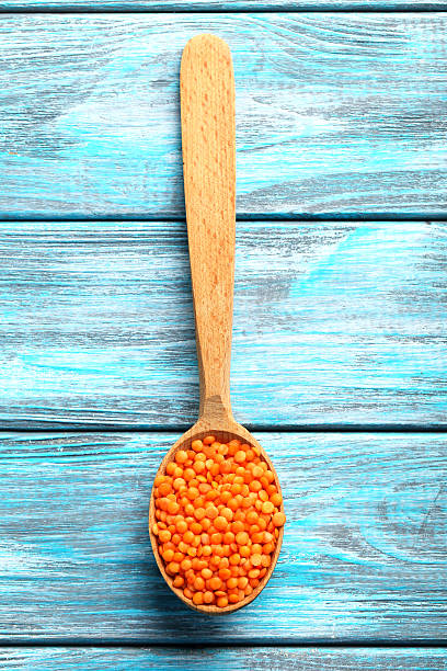 Red lentils in the wooden spoon