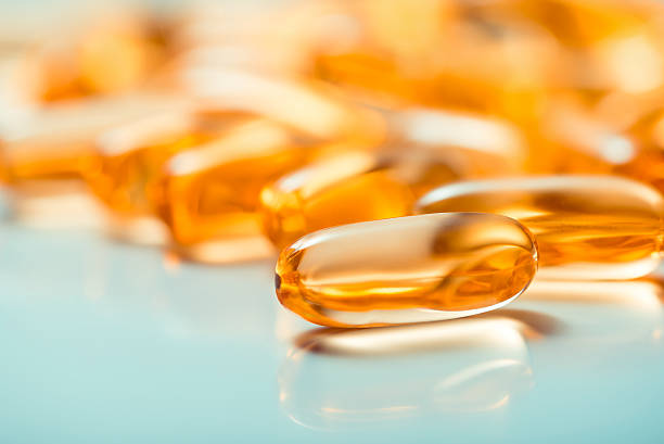 las cápsulas - cod liver oil capsule vitamin pill vitamin e fotografías e imágenes de stock