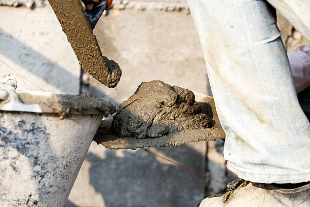 istock plasterer concrete worker at wall of house construction 531872894