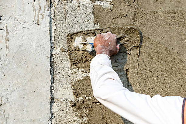 istock plasterer concrete worker at wall of house construction 531873116