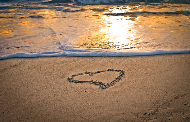 istock heart on the beach at sunset 531873856
