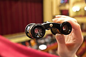 Theater binoculars in female hand