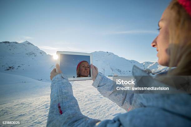 Woman On Ski Runs Taking Picture With Digital Tablet Stock Photo - Download Image Now