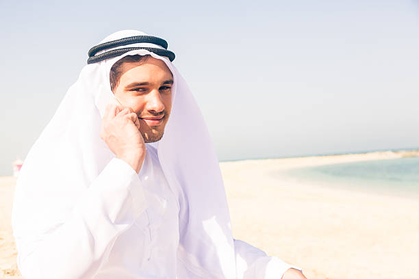 istock young arabian man sitting at the beach 531884329