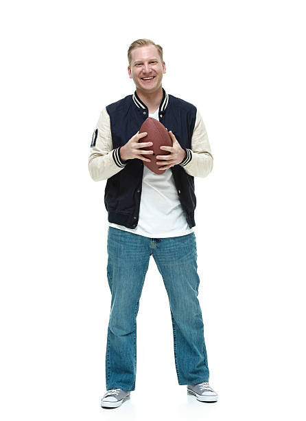 istock Smiling college student holding football 531887425