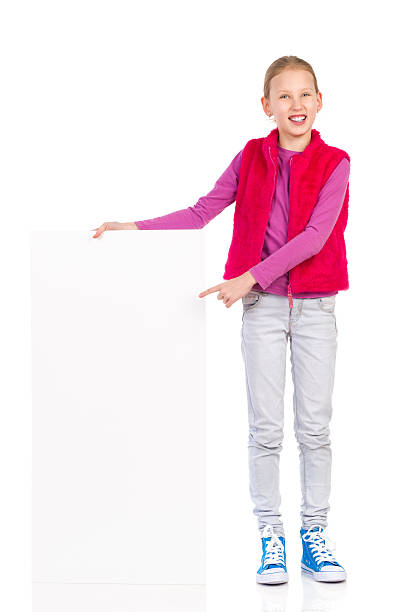 istock Little girl pointing at blank banner. 531889019