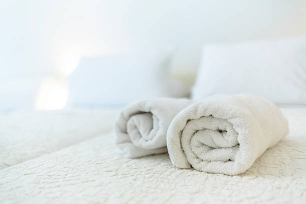 istock White towels on a bed in hotel room. 531889161