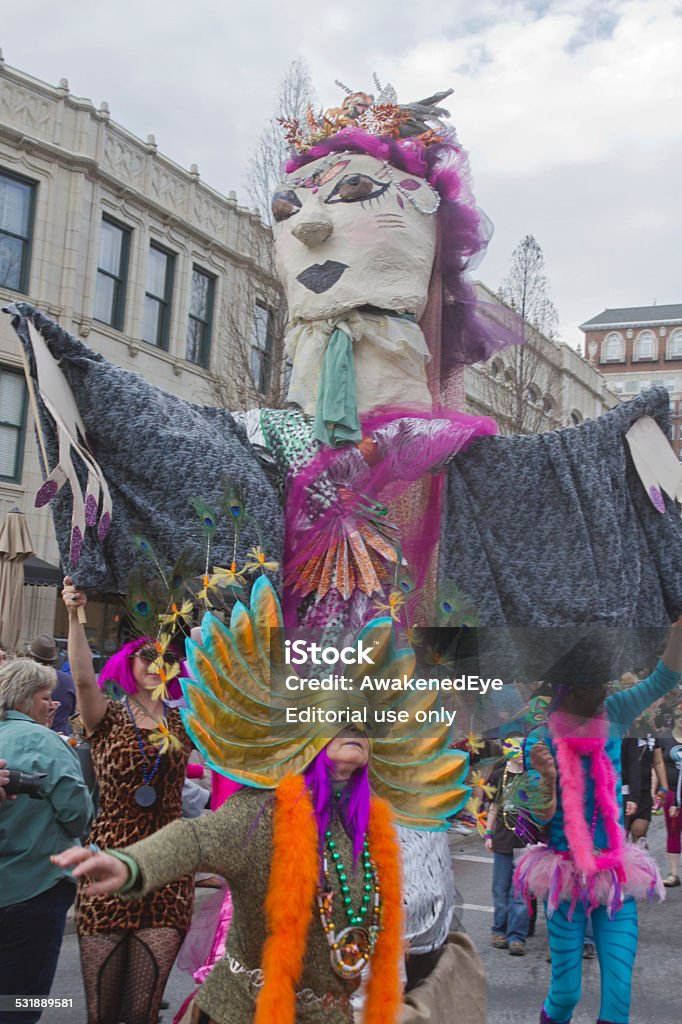 Exotic Mardi Gras Celebrants Asheville, North Carolina, USA - March 2, 2014:  Huge puppets and people wearing wildly creative costumes have fun celebrating in the Mardi Gras parade on March 2, 2014 in downtown Asheville, North Carolina 2015 Stock Photo