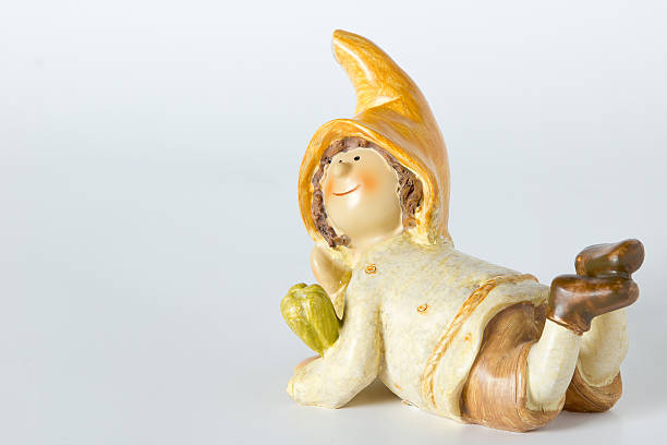 vintage German toy dwarfs with corn on white background