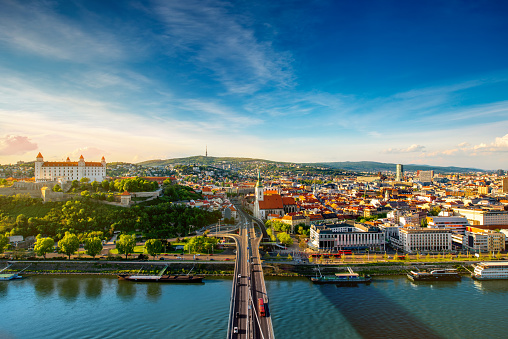 Bratislava aerial cityscape view on the old town with Saint Martin's cathedral, castle hill and Danube river on the sunset in Slovakia. Wide angle view with copy space