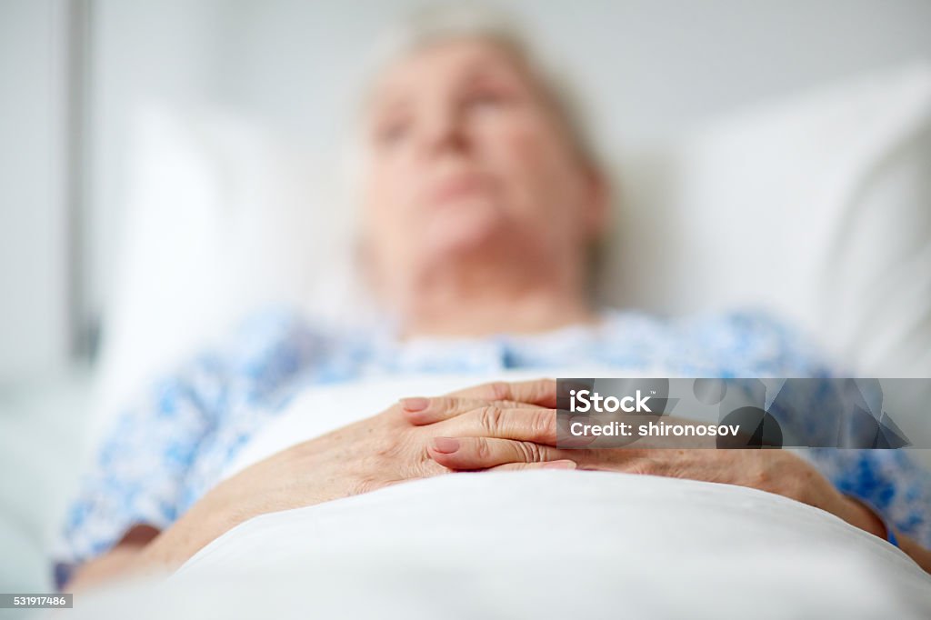 Senior woman in hospital Close-up of hands of senior woman lying in hospital ward Senior Adult Stock Photo