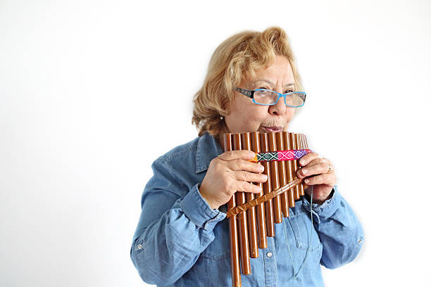 mulher sénior músico tocando flauta de pan @item: inlistbox - flute solo imagens e fotografias de stock