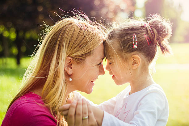 istock Young mother hugging her daughter in nature 531924374