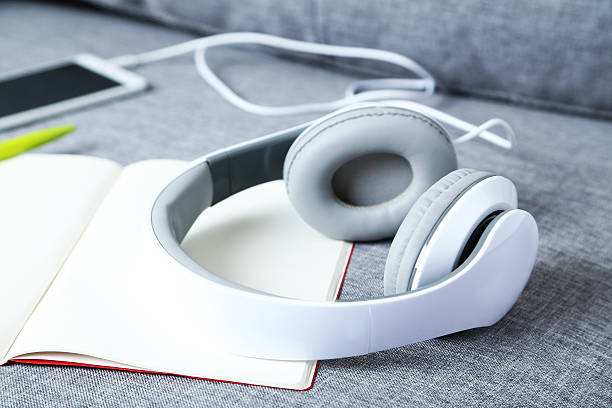 istock Headphones with smartphone on a grey sofa 531924538