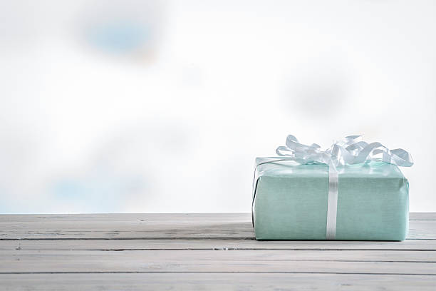 istock Gift in blue color on a wooden table 531924814