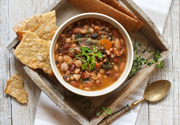 Cooked legumes and vegetables in a bowl Cooked legumes and vegetables in a bowl on the old wooden table soup lentil healthy eating dishware stock pictures, royalty-free photos & images