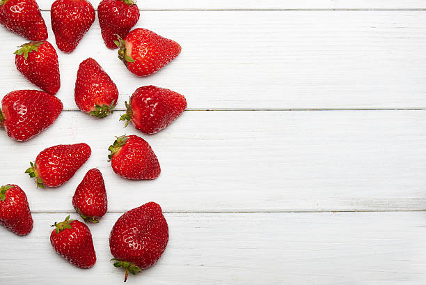 istock strawberry fruits on wooden background 531925432