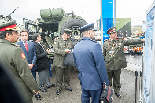 Nizhniy Tagil, Russia - September 26. 2013: Officers of foreign army get acquainted with materials on armored vehicle. RAE-2013 exhibition (Russian Arms Expo)