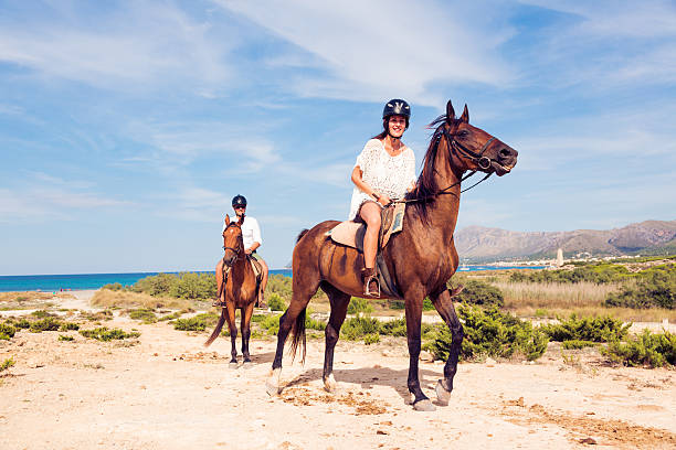 istock young tourist couple horseback riding 531927117