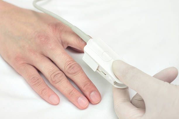 istock Doctor in a glove puts the sensor on patient's finger. 531927705