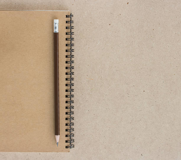 istock Small notepad with pencil and on wood background 531927880