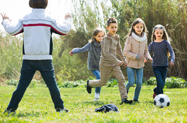 istock children running after ball 531928608