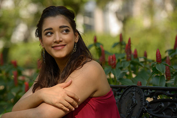 istock Indian woman sitting on park bench 531928916