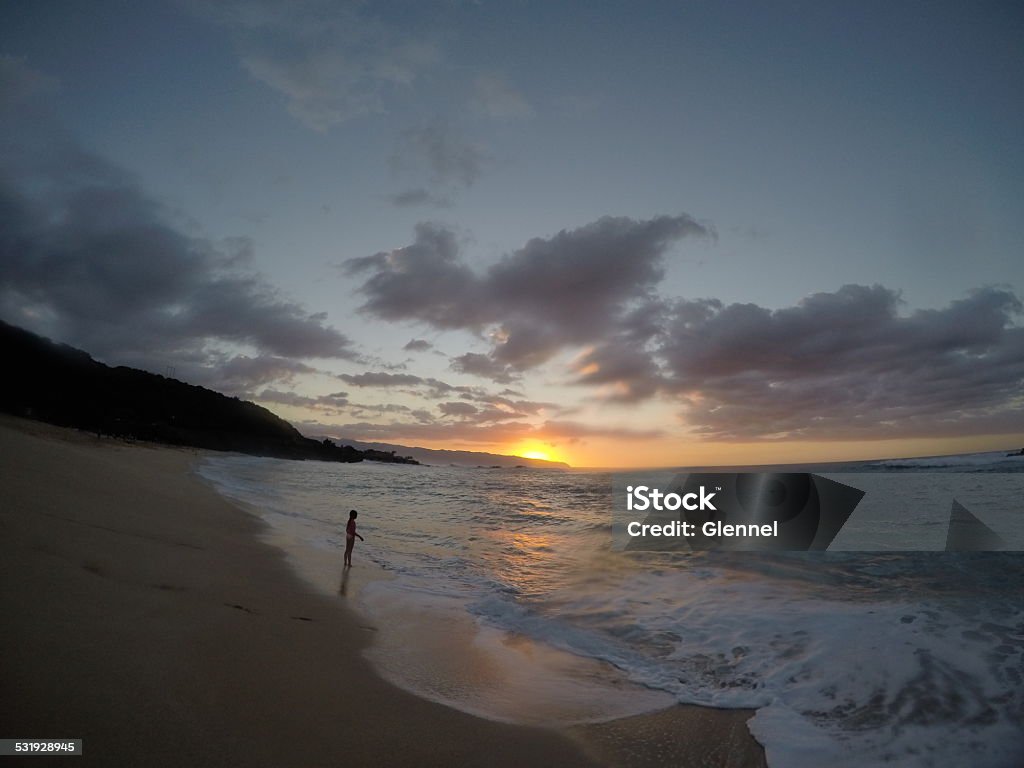 Barrel shot of a wave in Hawaii Winter surf on the North Shore of Oahu at Waimea Bay.  Sunset in Hawaii. 2015 Stock Photo