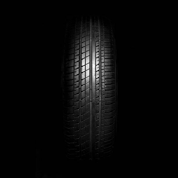 istock Car tires close-up on black background 531930047