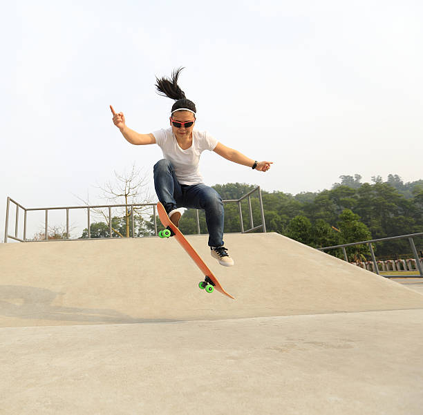 istock skateboarding woman practice ollie at skatepark 531931002