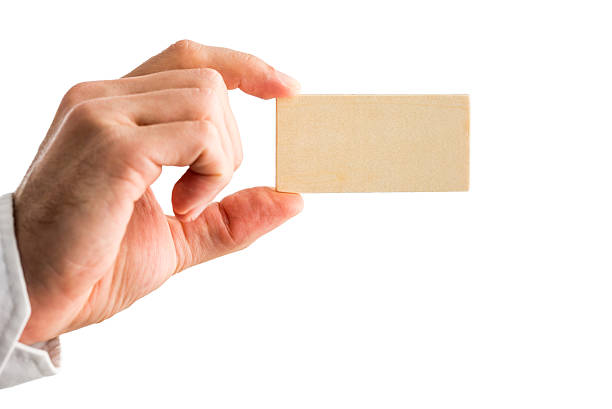 istock Man holding a small blank wooden block 531931921