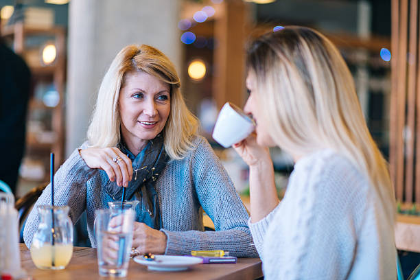 istock Mature mother talks to her daughter during coffee break 531932220
