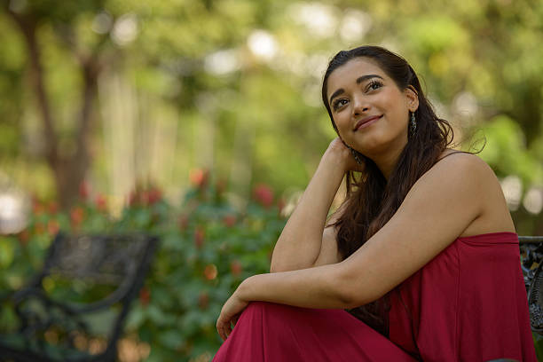 istock Indian woman sitting on park bench 531932782