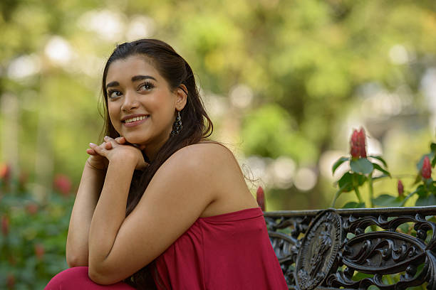 istock Indian woman sitting on park bench 531933198