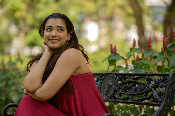istock Indian woman sitting on park bench 531933638