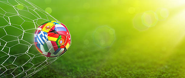 Goal - European Football Championship Ball with european flags in the net with green field background international team soccer photos stock pictures, royalty-free photos & images