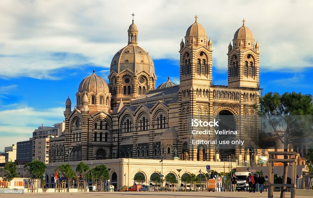 MARSEILLES, FRANCE - Cathedrale de la Major in Marseilles. Marseille, France - November 19, 2015 : Tourists walking in front of the Cathedrale de la Major in Marseilles. Built between 1852 and 1893, it is considered as one of the biggest cathedrals of its time. Architectural Dome Stock Photo