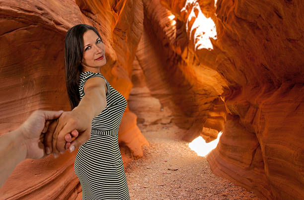 istock Woman pulling man down narrows red rock trail 531936838