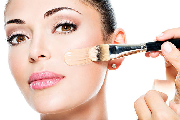 istock Makeup artist applying liquid tonal foundation  on the face 531939230