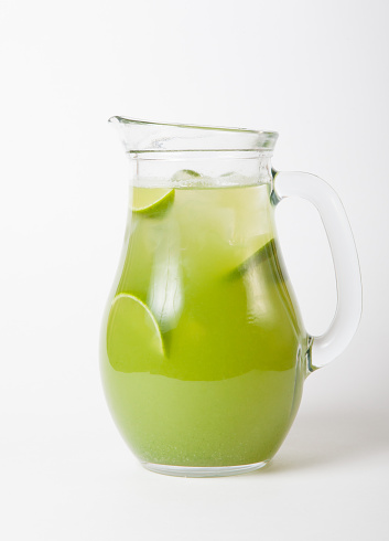Glass jug with green iced lime lemonade
