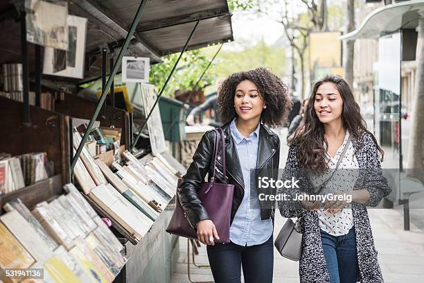Two Female Friends Walking Past Bookshop Stock Photo - Download Image Now - Paris - France, Friendship, Shopping