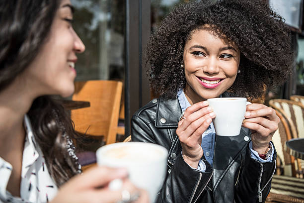 istock Young women drinking coffee in cafe, smiling 531941430